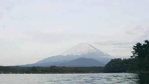 View of Mount Fuji in the distance over the water with soft natural lighting. Wi Stock Footage 199457761