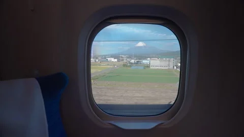 View of Mount Fuji through the window onboard a high speed train in Japan Stock Footage 257395764