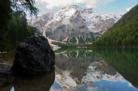 View of Mount Seekofel mirroring in the clear calm water of iconic mountain l Stock Photos