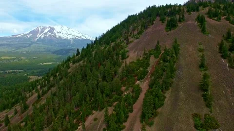A view of Mount Shasta from behind Black Butte mountain on a bright summer day Stock Footage 52137057