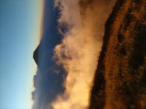 View of Mount Sindoro from the side of Mount Sumbing,blur background. Stock Photos