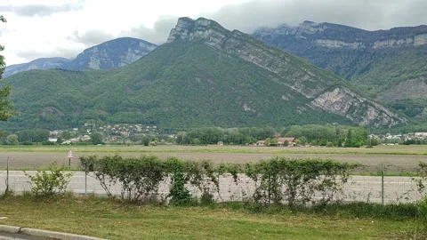 View of the mountain and road and trucks passing by Stock Footage 153484968