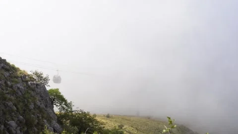 View of the mountain cable car and funiculars moving through the clouds Stock Footage 279024631