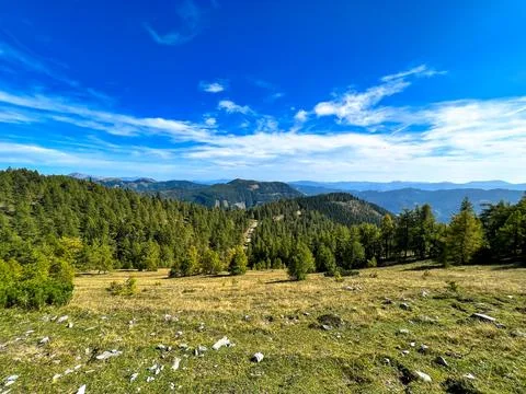 View of a mountain clearing on top of a mountain against a blue sky Stock Photos