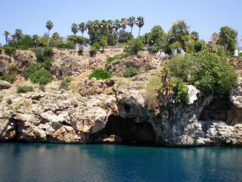 View of the mountain cliffs with the grotto of the city of (Antalya,  Turkey) Stock Photos