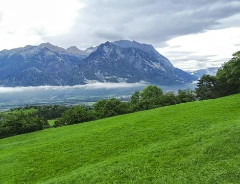 View from the mountain. Clouds, sky, green grass, mountains. Switzerland Stock Photos