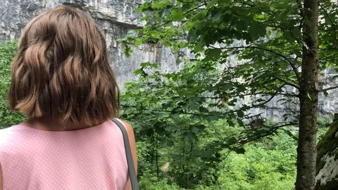 View of a mountain gorge from over the shoulder of a young girl. Stock Footage 126318640