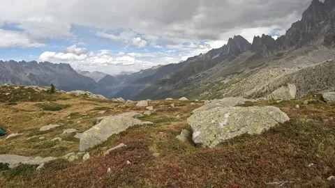 View of a mountain landscape with a rainbow, rainy weather in the French Alps Stock Footage 258023646