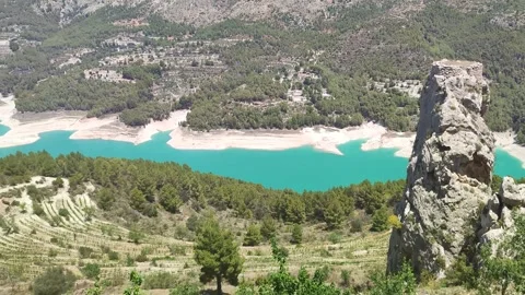 View from mountain to a lowland with  fields, lake. Spain, Guadalest Stock Footage 295562604