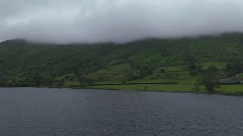 A view of a mountain panning backwards also with low clouds (drone shot) Stock Footage 312275914