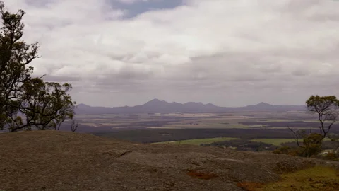 View from mountain peak across valley to magnificent mountain range Stock Footage 294894299