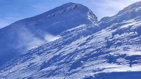 View of mountain peak on a very windy sunny day Stock Footage 230269599