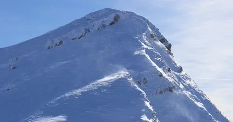 View of mountain peak on a very windy sunny day Stock Footage 230984674