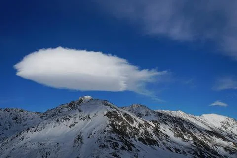 View of the mountain peaks with a cloud in the Caucasus Stock Photos
