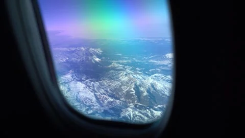 View of mountain peaks through airplane window Video stock 296187534
