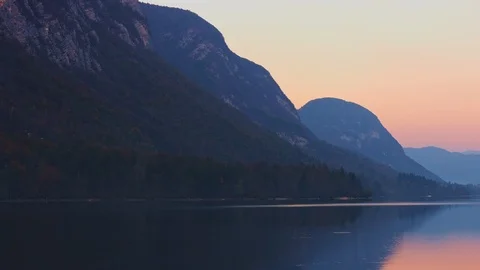 View of mountain range with reflection in water from the Bohinj lake, Slovenia. Stock Footage 119756731