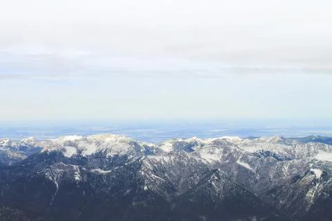 View of a mountain range with snow and clouds Stock Photos