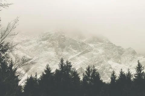 View of a mountain range with snow and clouds Stock-Fotos