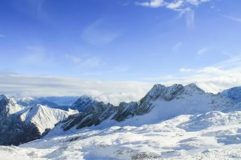 View of a mountain range with snow and clouds Stock Photos