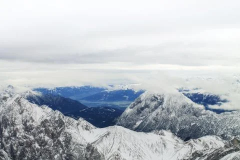 View of a mountain range with snow and clouds Stock Photos