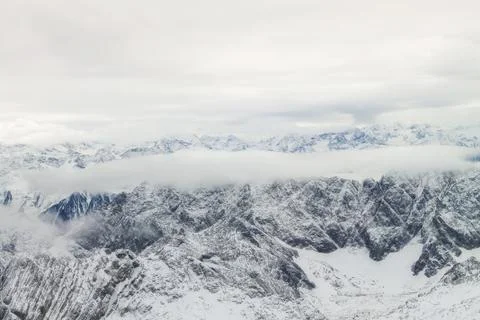 View of a mountain range with snow and clouds 스톡 사진