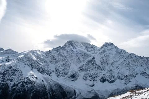 View of the mountain range, steep slopes and snow-capped rocky peaks. Stock Photos