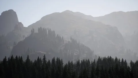 A view of a mountain range with trees in the foreground Stock Footage 273563805