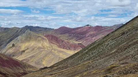 View of mountain range under a partly cloudy sky. Stock Photos