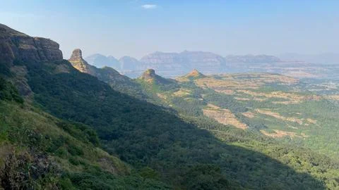 View of the mountain ranges while climbing up Ratangad Fort near Bhandardara  Stock Photos