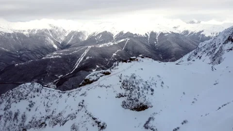 View of the Mountain Resort Ski Slope and People Skiing in the Mountains Stock Footage 246630136