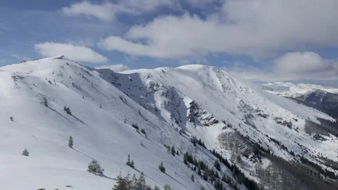 View of a mountain ridge during a sunny winter day Stock Footage 262531393