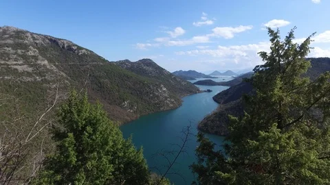 View on a mountain river flowing into a lake Stock Footage 87062386
