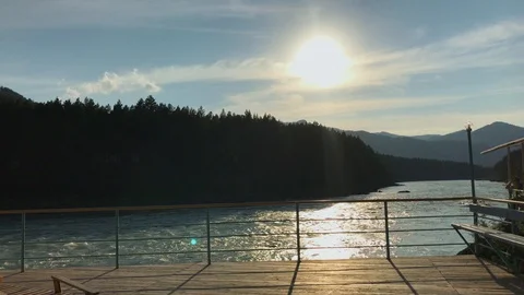 A view on a mountain river from a pier in the sunset Stock Footage 92670622