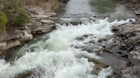 View from Mountain river waterfall through rocks to close up bubbling water Stock Footage 312076148