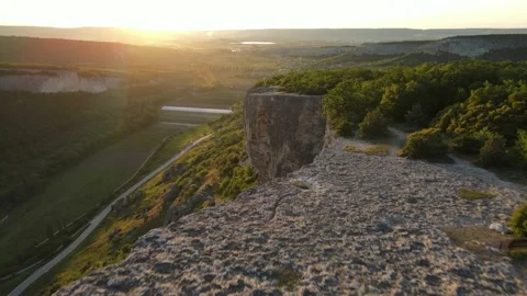 View from the mountain to the road and the settlement, quadrocopter. Crimea Stock Footage 155363817