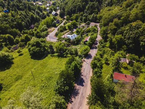 A view of a mountain road in the middle of a summer forest Stock Photos