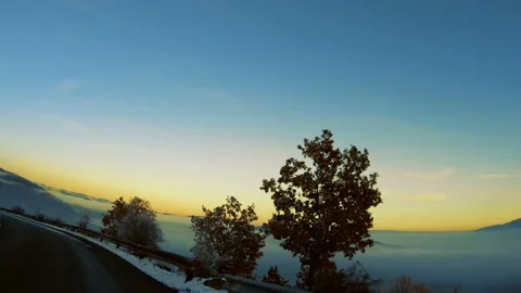 View of mountain road at sunset at high altitude. Valley covered with lake of Stock Footage 138791216