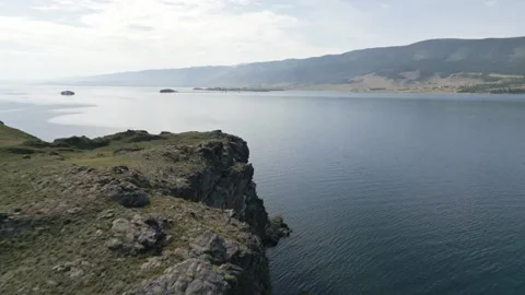 View of mountain rocks and blue clear water of the small sea of Lake Baikal Stock Footage 278442728