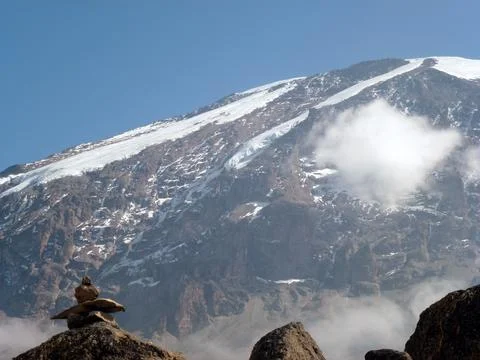 A view of the mountain slope on which small stones are falling and snow Stock Photos