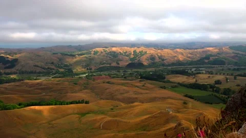 View from the mountain Te Mata Peak to clouds, river and hills with yellow grass Stock Footage 131774157