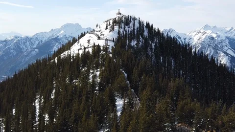 View of a mountain top cabin from another peak Stock Footage 104883770