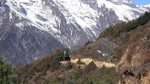 A view of a mountain trail and a prayer flag in the Himalaya Mountains on Stock Footage 175264661