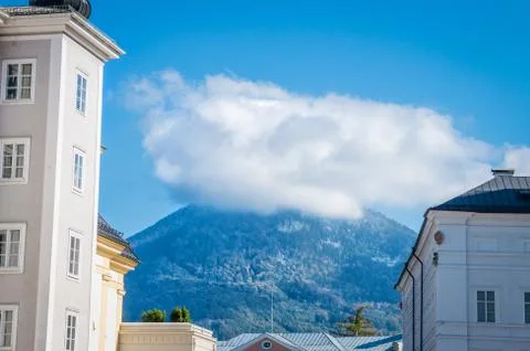 View to mountain under cloud between two buildings in Salzburg Austria Stock Photos