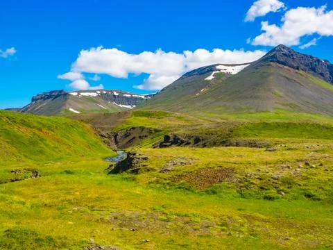 View of mountain, valley and stream in the blue sky Stock Photos