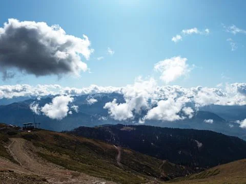 View of a mountain valley with bright blue sky and white clouds Stock Photos