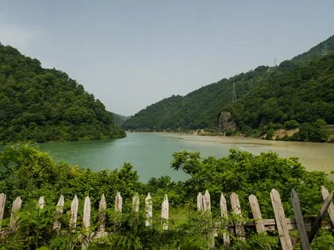 View of the mountain valley. The confluence of two different rivers into one Stock Photos