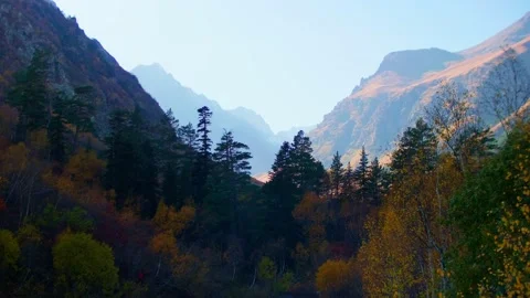 View of mountain valley covered with sunshine at background and with shadow at Stock Footage 145744835