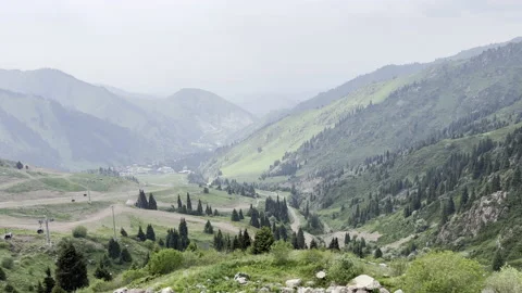 View of mountain valley down. Cableway in mountains. Green mountain slopes Stock Footage 200130104