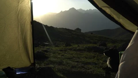 View of the mountain valley through the window in the camping tent Video stock 101010165