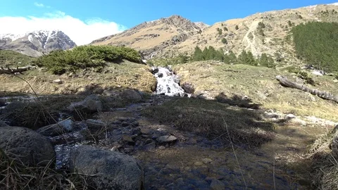 A view of mountain waterfall surrounded by mountains Stock Footage 90492183